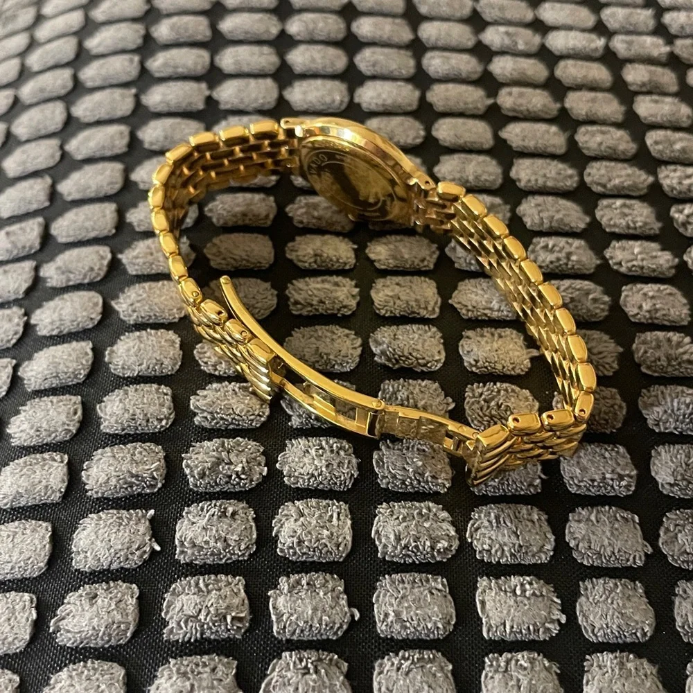 Movado black dial, gold tone bracelet strap watch
